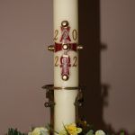 The Paschal Candle with a crucifix containing the Greek letters Alpha and Omega and surrounded by the numerals for this year, 2022.